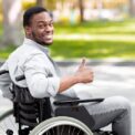 Happy Disabled Black Man in Wheelchair Spending Time at City Park in Autumn, Showing Thumb Up Gesture and Smiling Stock Photo - Image of handicap, recovery: 356214140